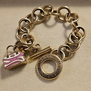 Dooney & Bourke Gold  Tone Bracelet with Pink And White Handbag Charm 7"
